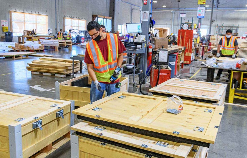Transpak employees crating large boxes.