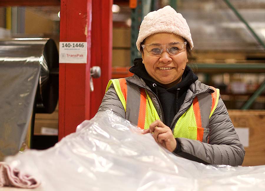 employee-preparing-plastic-protection-for-crate