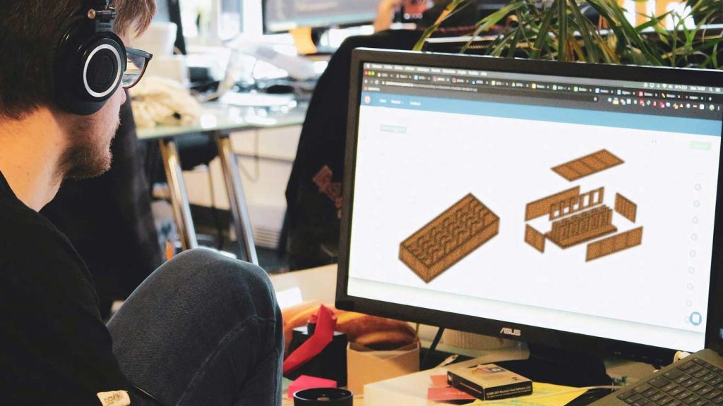 Transpak employee making a customized crate on the computer.