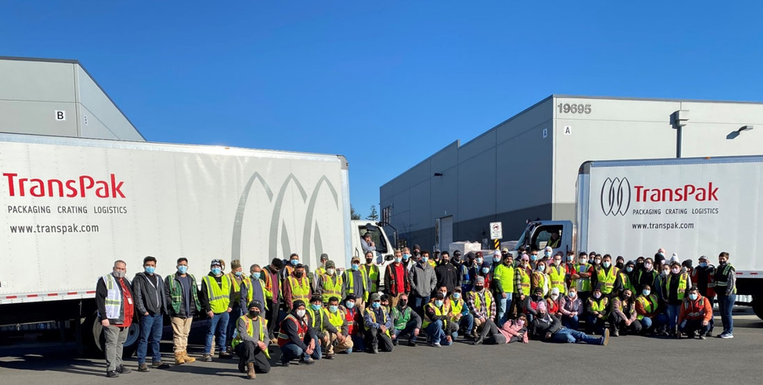 transpak-portland-oregon-facility-and-team-with-logistics-trucks-in-background