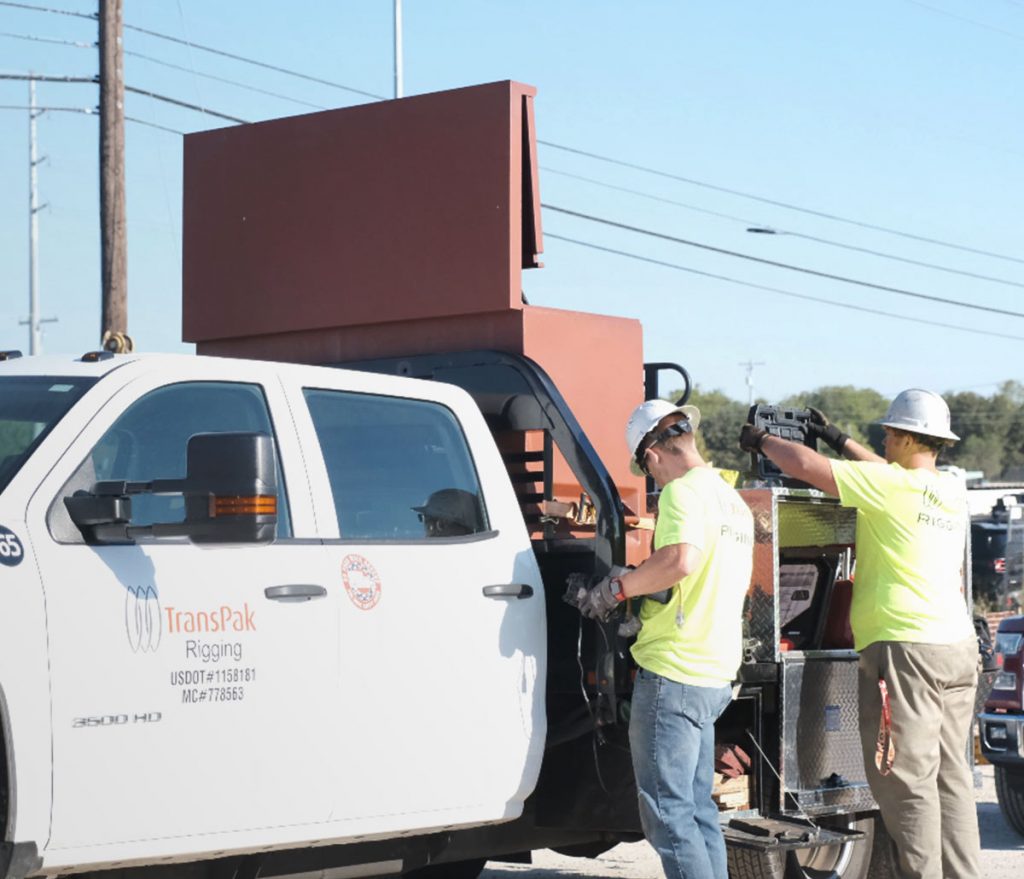 TransPak team performing rigging operations with heavy machinery.