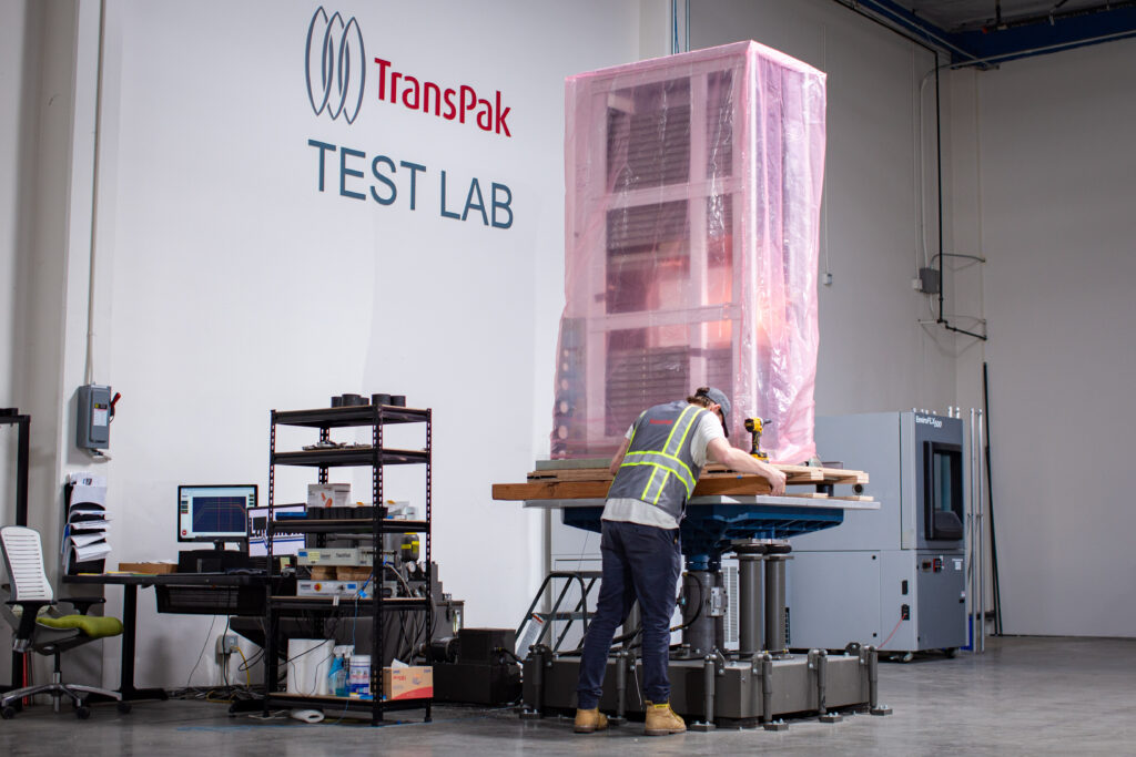 A TransPak engineer prepares a server rack for vibration table testing at the TransPak Test Lab facility